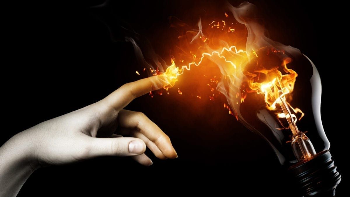 Image of a finger and lightbulb on fire