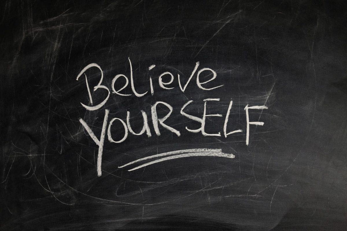 Image of a chalkboard with the words "believe yourself" written on it