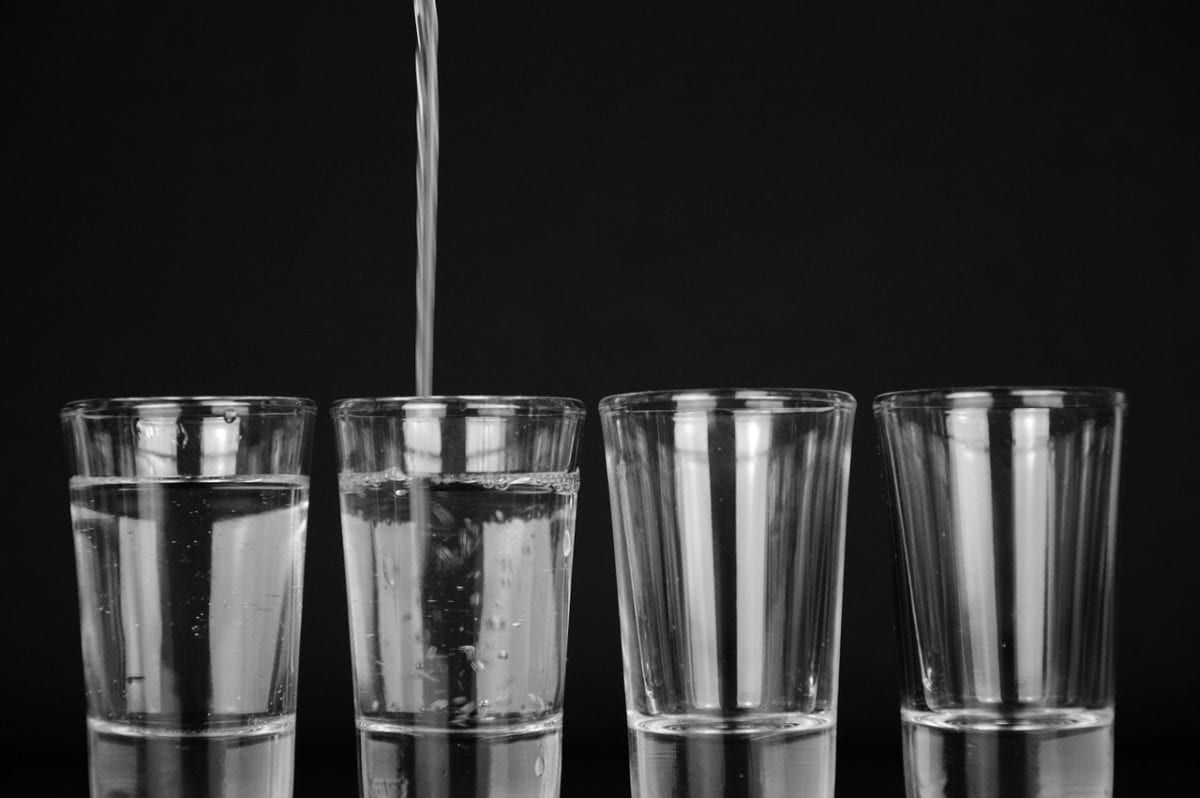 Image of glasses with water pouring into them