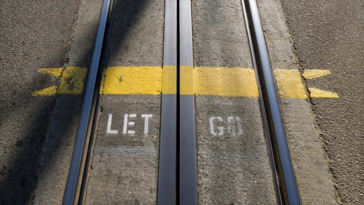 Image of train tracks and the words "let go"